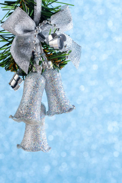 istock Silver christmas garland hanging on a ribbon on a blue background 1061018740