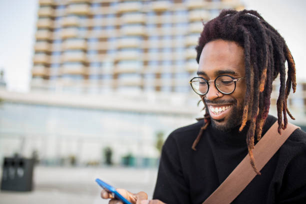 istock Handsome man sitting on a bench with a mobile phone 1061019244