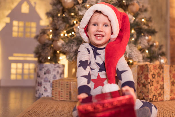 istock Happy little smiling boy with Christmas gift. 1061019530