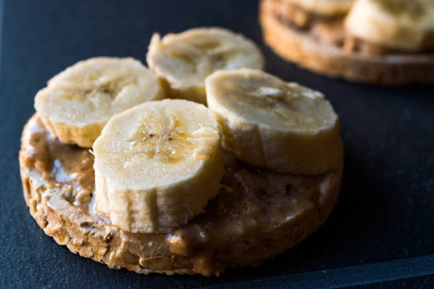 istock Bulgur Rice Cakes with Sliced Bananas and Peanut Butter / Round Crackers. 1061021408