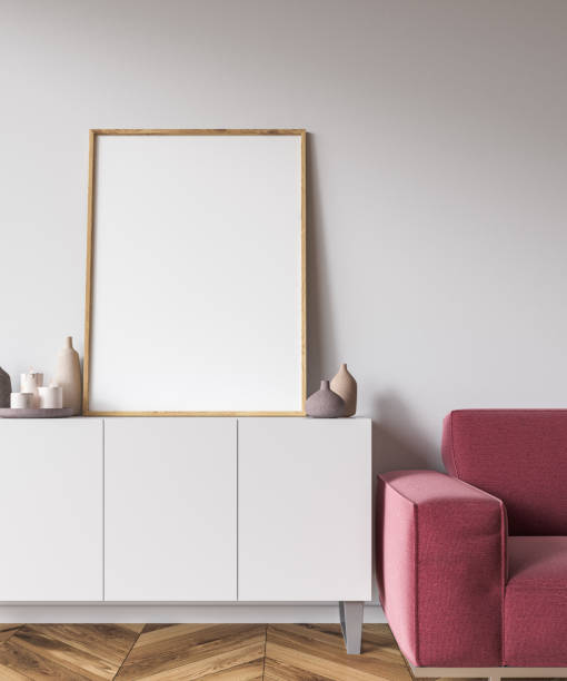 istock Vertical poster on white cabinet, couch 1061021506