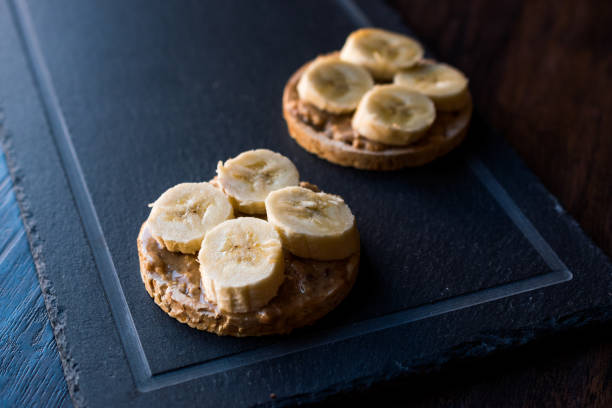 istock Bulgur Rice Cakes with Sliced Bananas and Peanut Butter / Round Crackers. 1061021592
