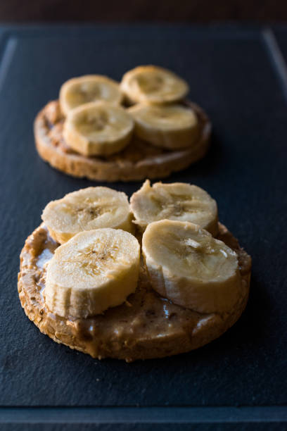 istock Bulgur Rice Cakes with Sliced Bananas and Peanut Butter / Round Crackers. 1061021820