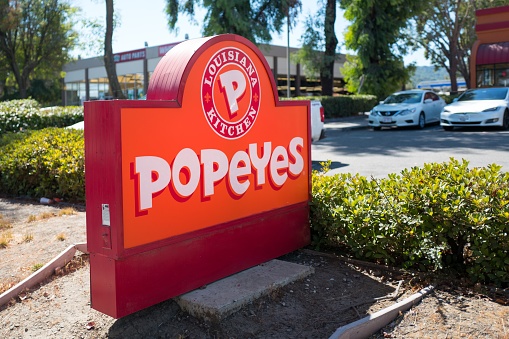 Dublin, California, United States - September 20, 2018:  Sign for Popeye's fast food restaurant with rebranded 