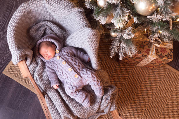 istock Baby boy sleeping under the Christmas tree on New Year's Eve 1061022564