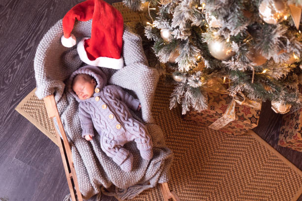 istock Baby boy sleeping under the Christmas tree on New Year's Eve 1061024498