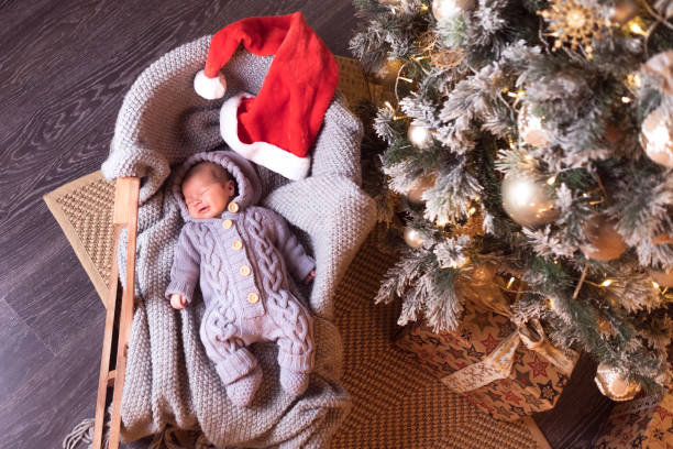 istock Baby boy sleeping under the Christmas tree on New Year's Eve 1061025000
