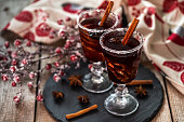 Mulled wine and frozen berries on the wooden table