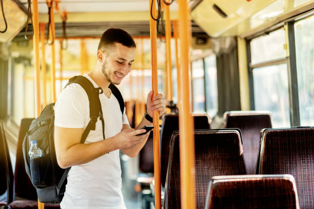 istock Young Man in the Bus with Smart Phone 1061026688