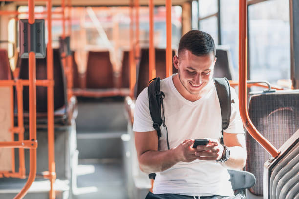 istock Young Man in the Bus with Smart Phone 1061026704