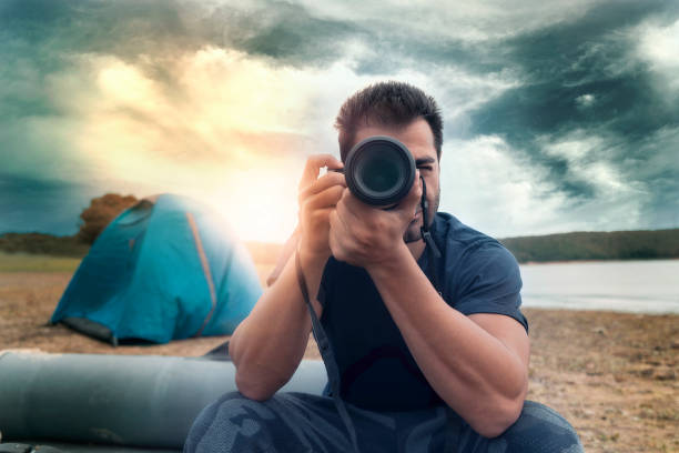 istock camping,man,sunlight,
photographer,tent 1061026902