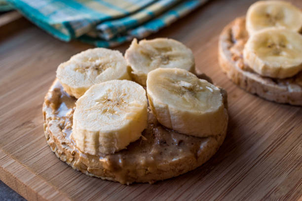 istock Bulgur Rice Cakes with Sliced Bananas and Peanut Butter / Round Crackers. 1061027280