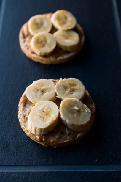 istock Bulgur Rice Cakes with Sliced Bananas and Peanut Butter / Round Crackers. 1061027730