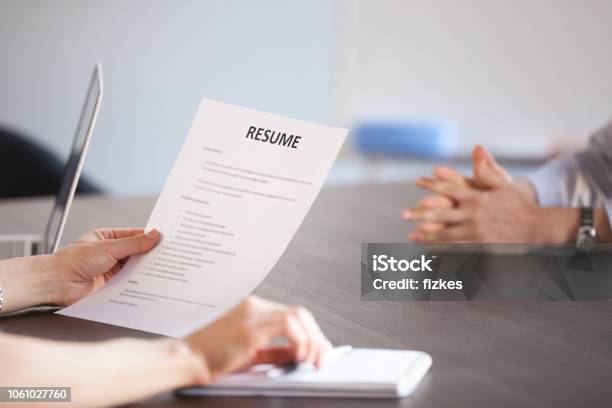 Hr Holding Reading Resume At Job Interview Close Up View Stock Photo - Download Image Now