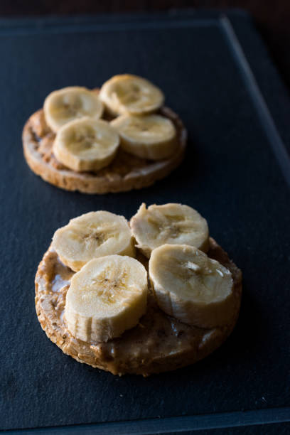 istock Bulgur Rice Cakes with Sliced Bananas and Peanut Butter / Round Crackers. 1061027908