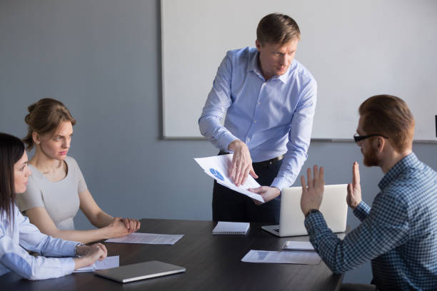 istock Stressed employee disagree with boss blaming for mistake in report 1061027914