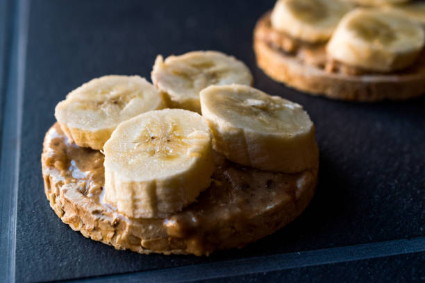 istock Bulgur Rice Cakes with Sliced Bananas and Peanut Butter / Round Crackers. 1061028488