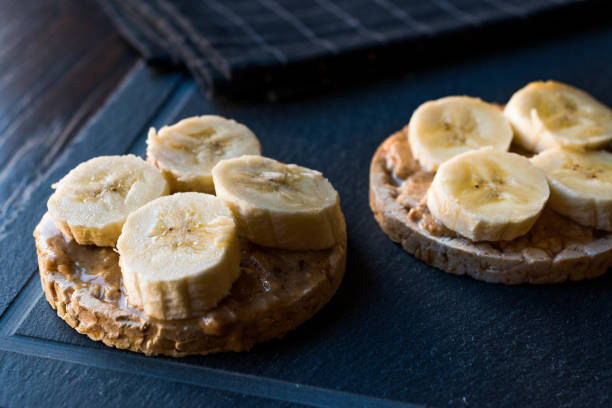 istock Bulgur Rice Cakes with Sliced Bananas and Peanut Butter / Round Crackers. 1061029650