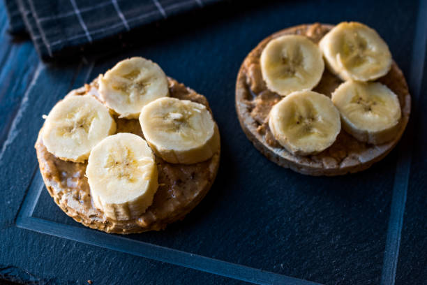 istock Bulgur Rice Cakes with Sliced Bananas and Peanut Butter / Round Crackers. 1061029904