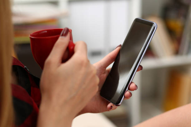 istock woman drinking coffe and look at laptop 1061030458
