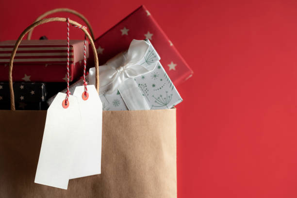 istock Two blank tags and a bag full of gifts 1061030944