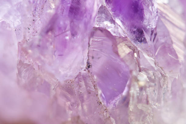 Amethyst natural mineral,  beautiful abstract lilac Macro background. Natural light translucent crystal, extreme close-up.