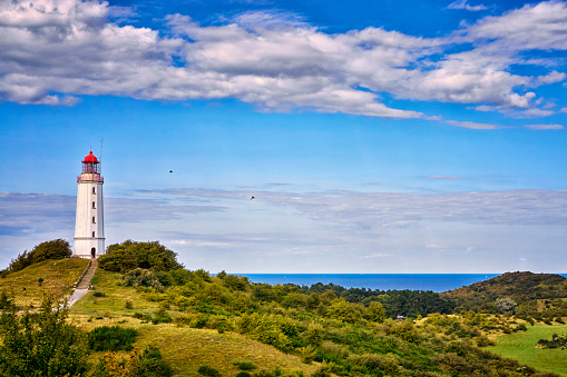 Classic view of the famous lighthouse Dornbusch on the beautiful island Hiddensee with a view of the Baltic Sea, Mecklenburg-Vorpommern, Germany