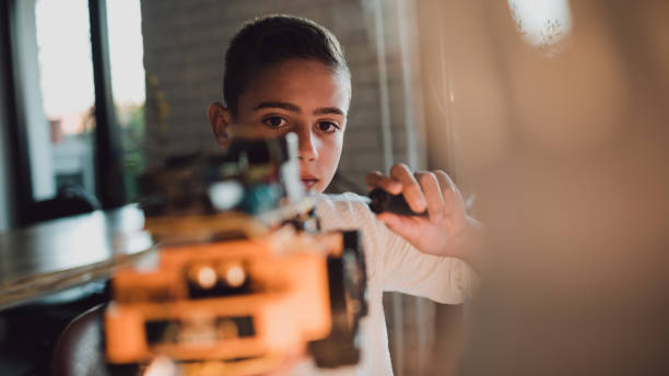 istock Pre-adolescent boy working on electronic project at home 1061033948