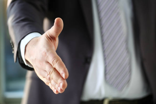 istock Man in suit and tie give hand as hello in office 1061035076