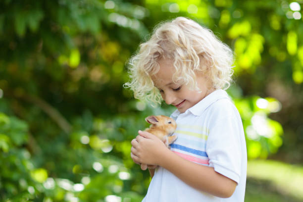 istock Child with rabbit. Easter bunny. Kids and pets. 1061037256