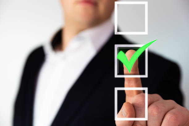 Businessman pushing checkbox button with a green tick.