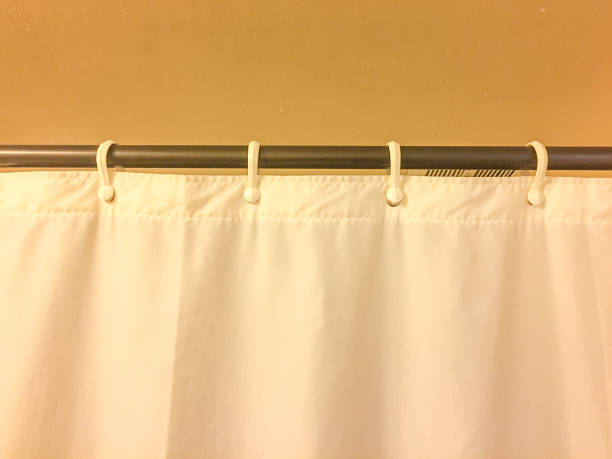 istock White plastic shower curtain hanging from a rod 1061040668