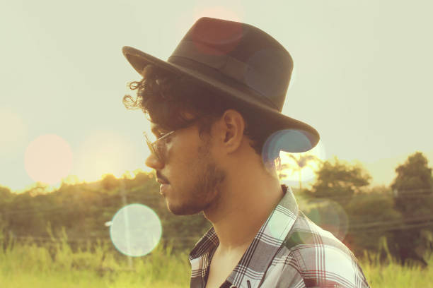 istock Young hipster guy with beard and hat in the forest. 1061040972