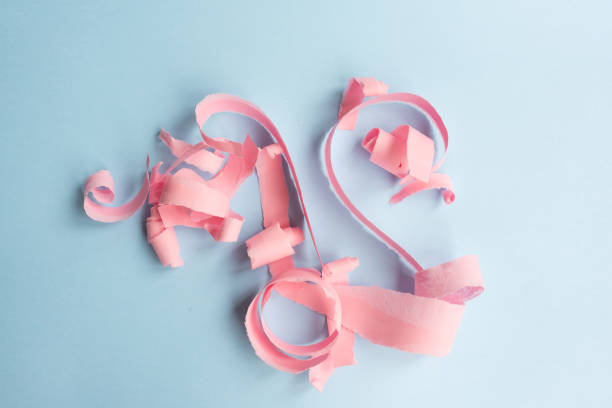 istock Abstract background - torn pink paper on blue 1061051398