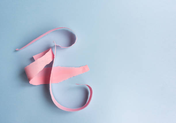 istock Abstract background - torn pink paper on blue 1061054288