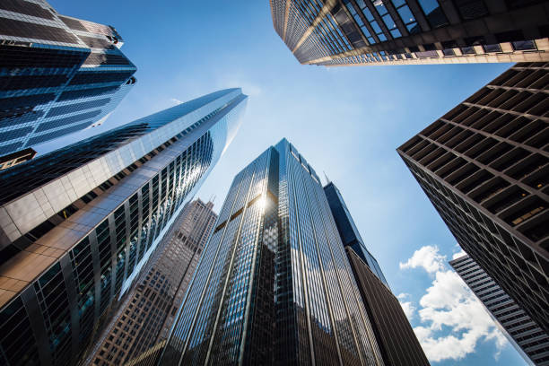 Chicago Urban Skyscrapers USA Modern urban skyscrapers in downtown Chicago from below to the blue summer sky. Sun reflecting in the glass facades of the urban futuristic buildings. Chicago, Illinois, USA low angle view stock pictures, royalty-free photos & images