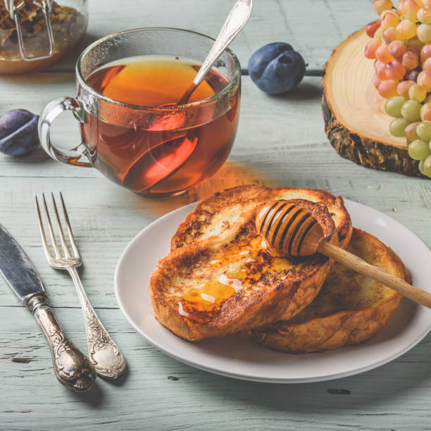 french toasts with honey, fruits and tea - french toast breakfast food sweet food imagens e fotografias de stock