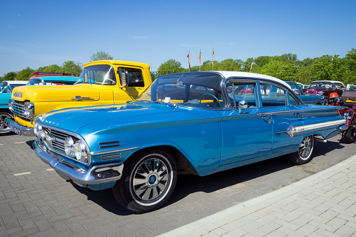 ROSMALEN, THE NETHERLANDS - MAY 8, 2016: Vintage 1960 Chevrolet Impala classic car in blue color parked in the car park.