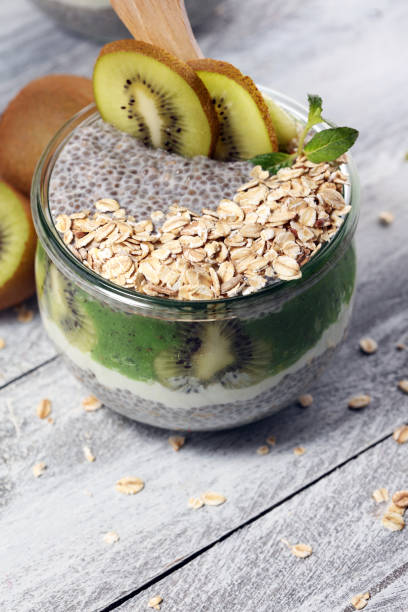 istock Healthy breakfast. chia pudding with kiwi and granola in glass on rustic background. 1061060632