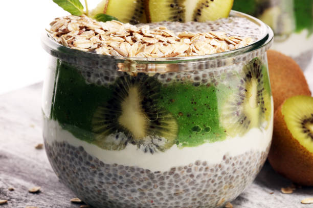 istock Healthy breakfast. chia pudding with kiwi and granola in glass on rustic background. 1061060794
