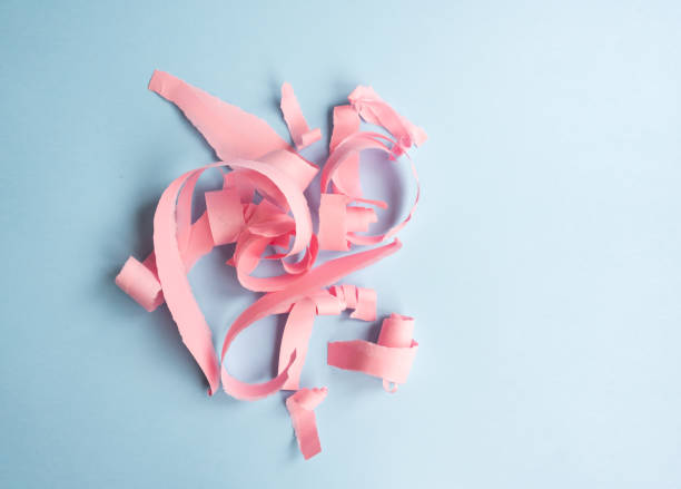 istock Abstract background - torn pink paper on blue background 1061062630