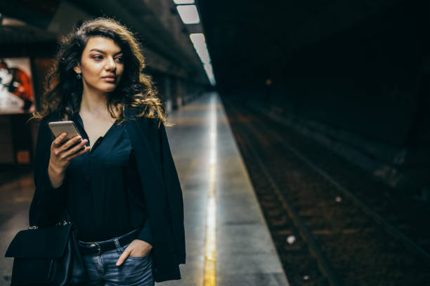 istock Lonely young female on empty subway station waiting for the train. 1061067342