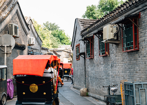 Chinese old street Hutong and traditional rickshaw at Shichahai in Beijing, China