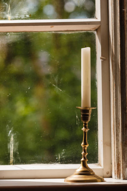 istock Old vintage window and vertical candle in candlestick 1061084572