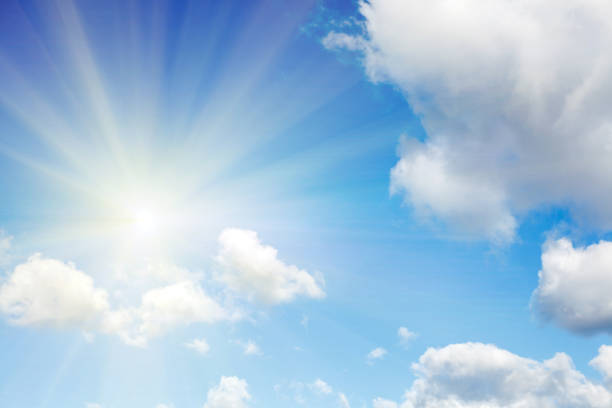 istock clouds against a blue sky with rays of the sun 1061084810