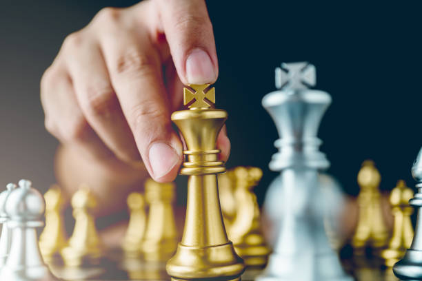 istock businessman hand control chess play figure business strategy manage ideas concept retro image tone 1061085140
