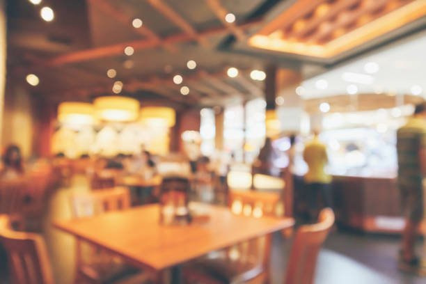 istock Restaurant interior with customer and wood table blur abstract background with bokeh light 1061085228