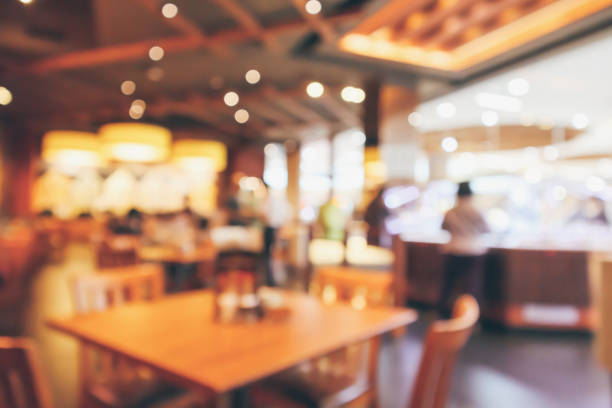 istock Restaurant interior with customer and wood table blur abstract background with bokeh light 1061085236