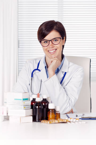 istock Smiling friendly female doctor in an office 1061085412