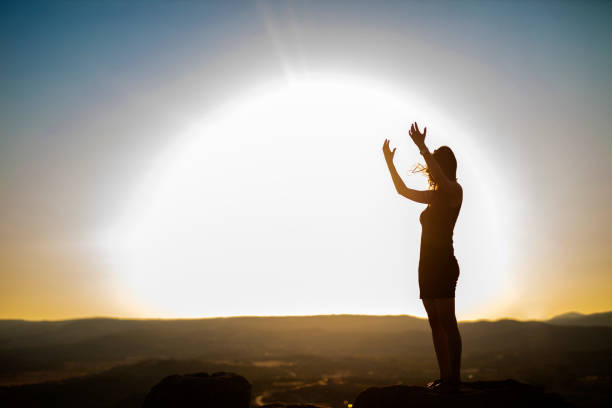 istock Woman is Praying on Mountain 1061085416